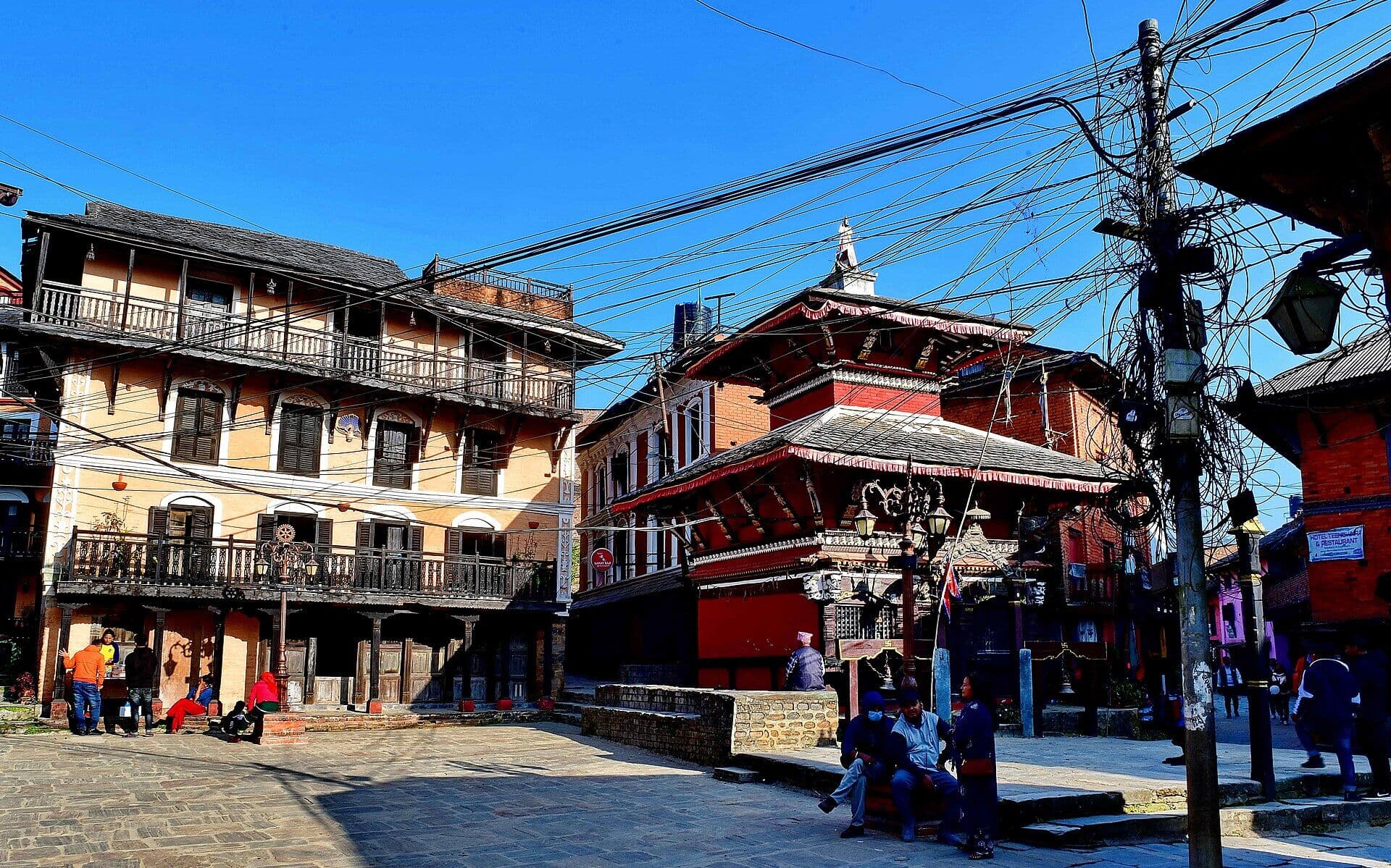 Bindhebasini Temple and traditional Newari houses in Bandipur under a clear blue sky